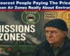 A digital illustration titled “EMISSIONS ZONES” features a distressed elderly man wearing a navy beanie and jacket, standing beside a smoking, old green car entering a designated clean air zone. Surrounding him are symbolic signs: a green “CLEAN ZONE” badge, a yellow “PENALTY CHARGE” notice, and a glowing gold coin with a pound symbol, highlighting the financial burden. The scene has a muted, somber tone with dark smog in the background, conveying themes of economic hardship and environmental enforcement.