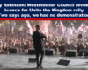 Expose News: Man on stage addressing lively crowd with flags at Unite the Kingdom rally; licence revoked by Westminster Council just two days prior.