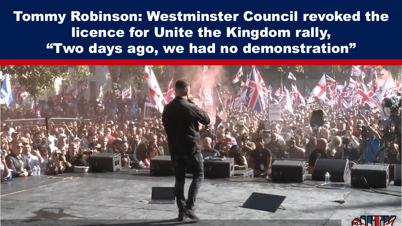 Tommy Robinson on stage addressing the Unite the Kingdom rally - The Expose Expose News: Man on stage addressing lively crowd with flags at Unite the Kingdom rally; licence revoked by Westminster Council just two days prior.