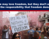 Expose News: Crowd rallying in the streets with signs demanding freedom amidst colorful smoke. Freedom attracts, but responsibility follows.